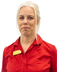 Sarah Wilding headshot Sarah Wilding in red nurse's uniform